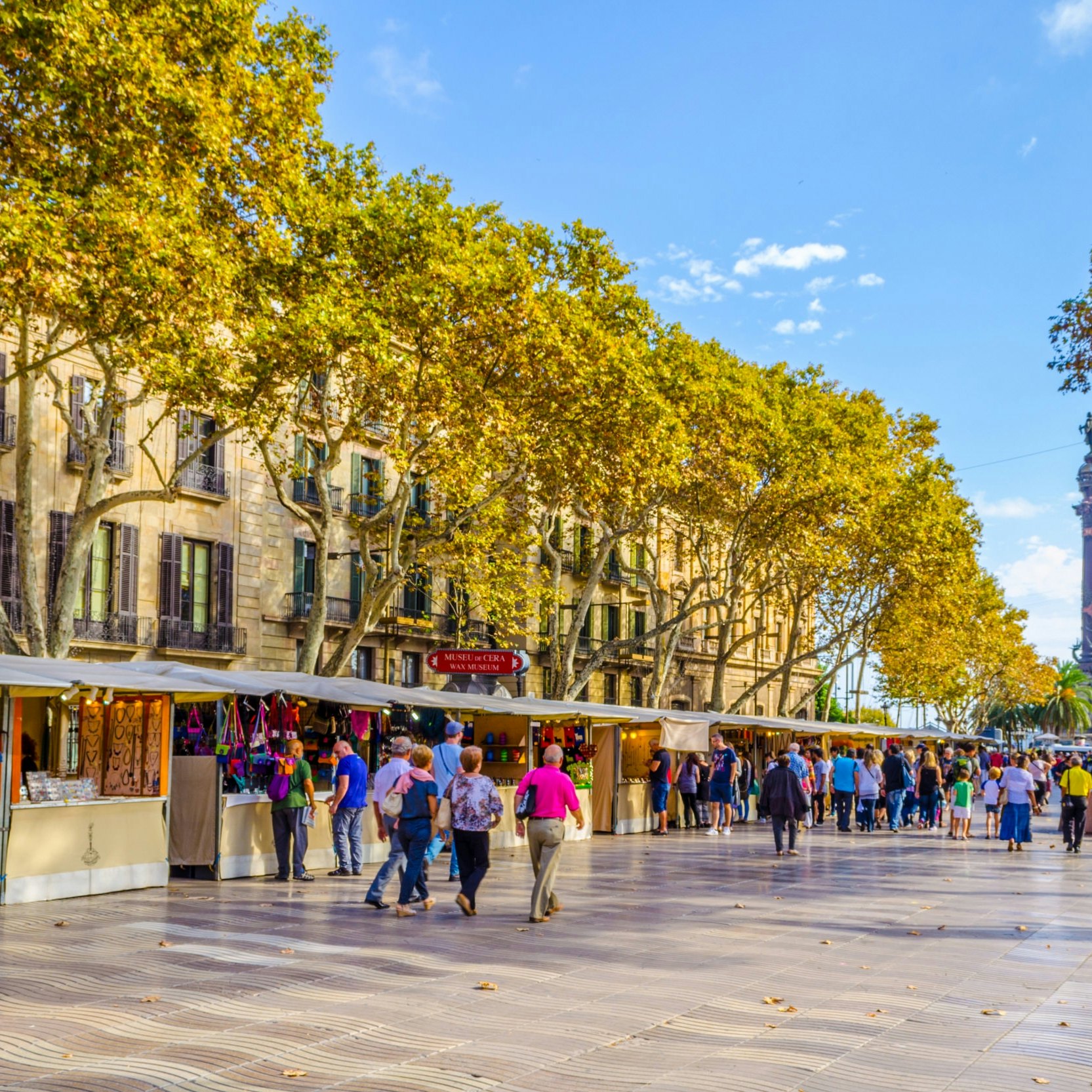 OCTOBER 26, 2014: People walking past market stalls on the La Rambla street in Barcelona.